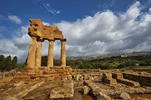 Temple of Dioscuren, temple ruins in sandstone landscape under dramatic sky