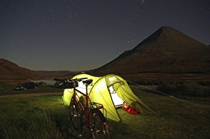 Category Mountain Landscapes Prints: Tent illuminated with a torch in front of rugged mountains
