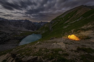 Category Mountain Landscapes Prints: Tent in mountainous landscape with Lake Guffelsee in moonlight and cloudy sky