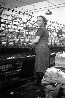 Textile industry, woman works in a spinning mill