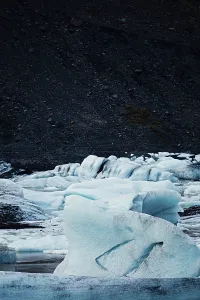 Textured ice formations stand out against a dark