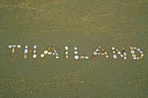 Thailand written with shells in the sand on the island of Ko Lanta
