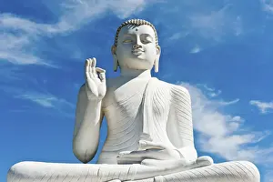 Theravada Buddhism, white statue of Buddha seated in the lotus position