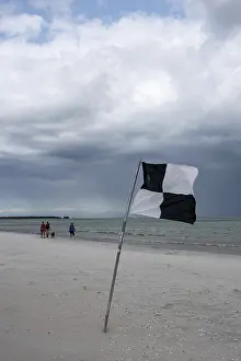 Thick, dark rain clouds gather over the Baltic Sea