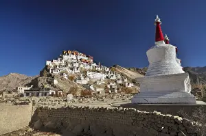 Thiksey monastery bathing in sunlight surrounded by mountains