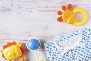 Things for a newborn on a white wooden background