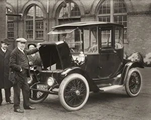 Thomas Alva Edison displaying storage batteries of the power Detroit Electric automobile