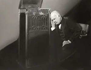 Thomas Alva Edison listening to his disc phonograph