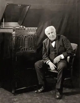 Thomas Alva Edison listening to his disc phonograph