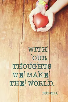 With our thoughts we make the world - famous Buddha quote printed on image of hands with heart