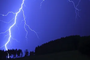 Thunderstorm, lightning striking a forest