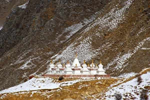 Tibetan Buddhism stupas on snow covered slope Drak Yerpa Tibet China