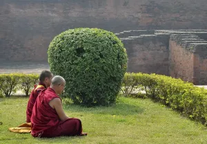 Tibetan Buddhist monks in red robes in meditation