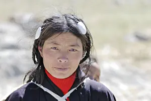 Tibetan pilgrim with hair jewellery walking around the mountain at Namtso Lake