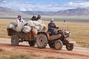 Tibetan pilgrims on a tractor on the road from Gerze to Tsochen