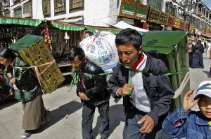 Tibetian with heavy load on the Barkor (walk around the Jokhang temple)