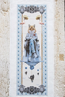 Tile image on a wall, fox sitting on a chair