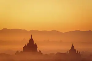 Tilt Shift blur effect. Amazing misty sunrise colors and silhouettes of ancient Sulamani and Tha Beik Hmauk Gu Hpaya