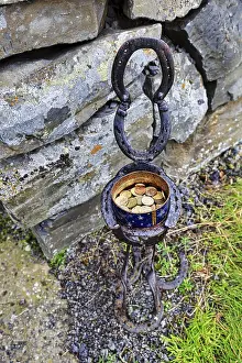 Tin with coins, donations for visiting a church