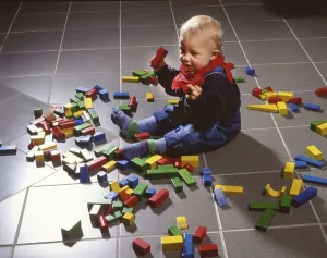 Toddler playing with building blocks