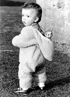 Toddler wears ferret in hood, England