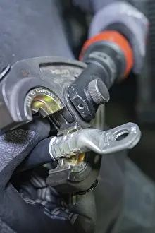Category Historic EN Prints: Detail of a tool in use for processing an electrical cable
