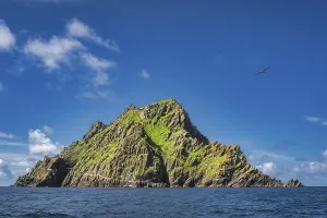 Tour boats docking to Skellig Michael island with monks hermitage on top