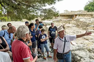 Tour guide in front of the Minoan temple complex of Knossos
