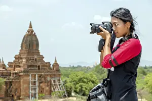 The tourist in Burma is photographing historical monuments