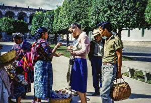 Tourist buying a souvenir from a local Mayan street vendor Antigua, Guatemala, Central America around 1961, Central America