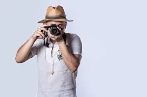 Tourist in a hat with a camera