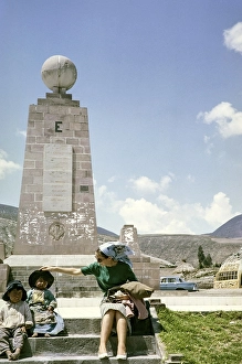Tourist with local children at the equator monument from 1936, Ciudad Mitad del Mundo, Pichincha, Ecuador, South America 1962, South America