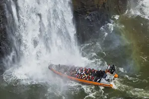 Tourists in a boat, at the foot of the Iguazu Falls