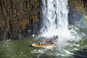 Tourists in a boat, at the foot of the Iguazu Falls