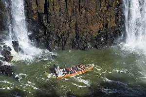 Tourists in a boat, at the foot of the Iguazu Falls
