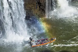 Tourists in a boat, at the foot of the Iguazu Falls