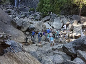 Tourists on boulders, climbing