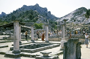 Tourists exploring the Roman archaeological site in Glanum, St Remy de Provence, France 1975