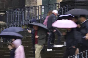 Tourists in rainy weather with umbrellas