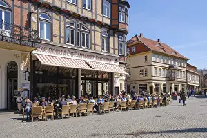 Tourists sitting outside a restaurant on the market square