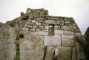 Tourists standing in front of huge stone blocks used for Inca masonry, Machu Picchu, Peru, South America, around 1962, South America