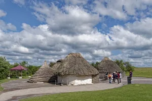 Tourists visit the replicas of Neolithic houses at the Stonehenge visitor centre