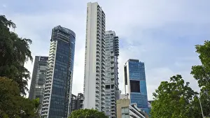 Towering modern skyscrapers with glass facades against a blue sky in an urban setting