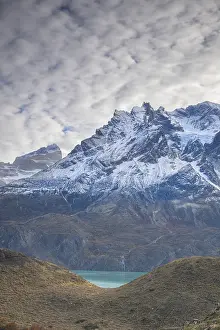 Towering snowy mountains beneath a moody