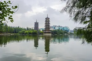 Two towers, pagodas of Sun and Moon by the lake