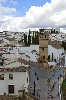 The town of Ronda with church and whitewashed buildings under a blue sky