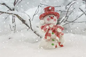 Toy of the snowman in snow