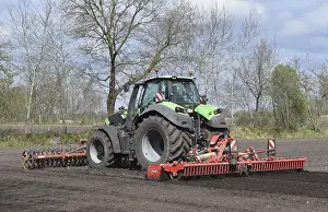 Tractor with harrows, disc harrows during tillage