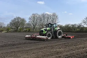 Tractor with harrows, disc harrows during tillage