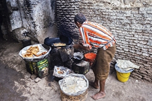 Traders preparing snacks in a dark alley in Zebid, Zabid, Yemen 1998 UNESCO World Heritage Site